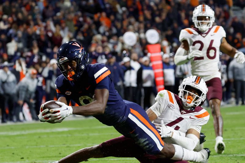 Nov 25, 2023; Charlottesville, Virginia, USA; Virginia Cavaliers wide receiver Malachi Fields (8) dives into the end zone as Virginia Tech Hokies cornerback Mansoor Delane (4) defends during the third quarter at Scott Stadium. Mandatory Credit: Geoff Burke-USA TODAY Sports