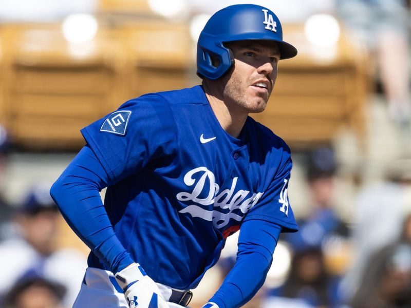 Mar 10, 2026; Phoenix, Arizona, USA; Los Angeles Dodgers first baseman Freddie Freeman hits an RBI double against the Arizona Diamondbacks during a spring training game at Camelback Ranch-Glendale. Mandatory Credit: Mark J. Rebilas-Imagn Images