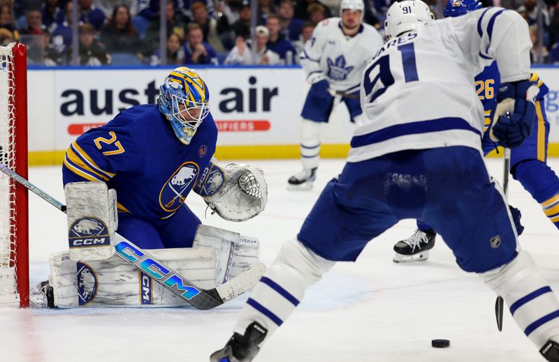 Dec 21, 2023; Buffalo, New York, USA;  Toronto Maple Leafs center John Tavares (91) looks to take a shot on Buffalo Sabres goaltender Devon Levi (27) during the first period at KeyBank Center. Mandatory Credit: Timothy T. Ludwig-USA TODAY Sports