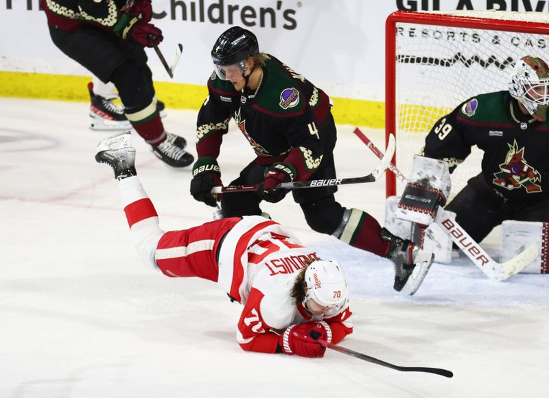 Jan 17, 2023; Tempe, Arizona, USA; Arizona Coyotes defenseman Juuso Valimaki (4) checks Detroit Red Wings center Oskar Sundqvist (70) to the ice in the second period at Mullett Arena. Mandatory Credit: Mark J. Rebilas-USA TODAY Sports