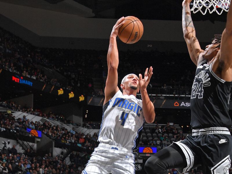 SAN ANTONIO, TX - MARCH 14: Jalen Suggs #4 of the Orlando Magic shoots the ball during the game against the San Antonio Spurs on March 14, 2023 at the AT&T Center in San Antonio, Texas. NOTE TO USER: User expressly acknowledges and agrees that, by downloading and or using this photograph, user is consenting to the terms and conditions of the Getty Images License Agreement. Mandatory Copyright Notice: Copyright 2023 NBAE (Photos by Michael Gonzales/NBAE via Getty Images)