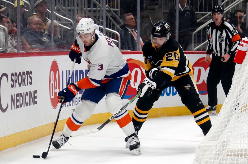 Feb 20, 2024; Pittsburgh, Pennsylvania, USA; New York Islanders defenseman Adam Pelech (3) moves the puck against Pittsburgh Penguins center Lars Eller (20) during the first period at PPG Paints Arena. New York won 5-4 in overtime. Mandatory Credit: Charles LeClaire-USA TODAY Sports