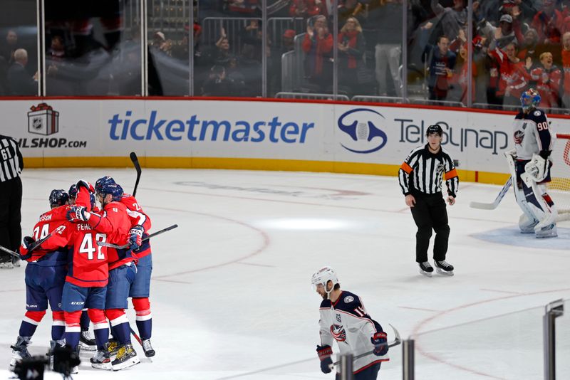 Nov 24, 2025; Washington, District of Columbia, USA; Washington Capitals defenseman John Carlson (74) celebrates with teammates after scoring a goal against the Columbus Blue Jackets during the second period at Capital One Arena. Mandatory Credit: Geoff Burke-Imagn Images