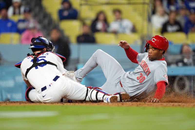 May 16, 2024; Los Angeles, California, USA; Los Angeles Dodgers catcher Austin Barnes (15) tags out Cincinnati Reds center fielder Will Benson (30) out at home plate in the ninth inning at Dodger Stadium. Mandatory Credit: Kirby Lee-USA TODAY Sports