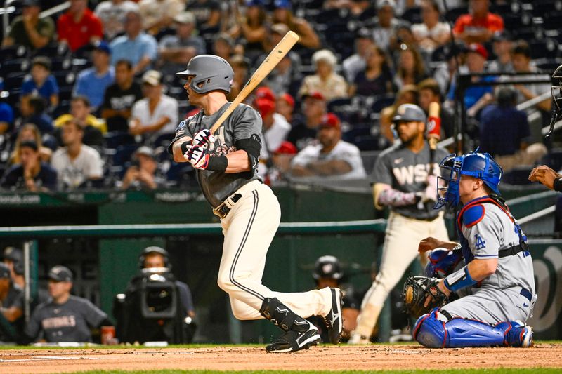 Sep 9, 2023; Washington, District of Columbia, USA; Washington Nationals designated hitter Lane Thomas (28) hits a RBI sacrifice fly against the Los Angeles Dodgers during the first inning at Nationals Park. Mandatory Credit: Brad Mills-USA TODAY Sports