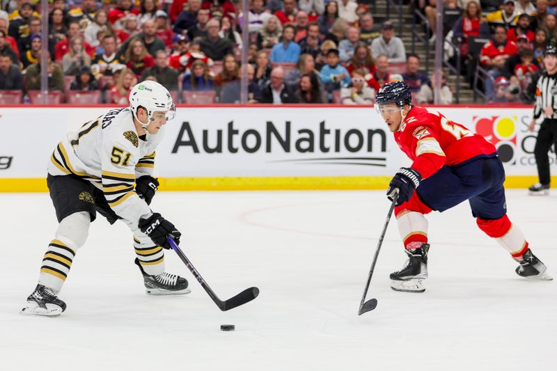 Nov 22, 2023; Sunrise, Florida, USA; Boston Bruins center Matthew Poitras (51) moves the puck against Florida Panthers defenseman Brandon Montour (62) during the first period at Amerant Bank Arena. Mandatory Credit: Sam Navarro-USA TODAY Sports