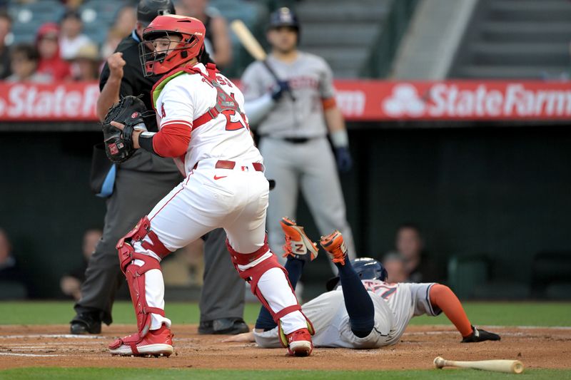 Jun 8, 2024; Anaheim, California, USA;    Los Angeles Angels catcher Matt Thaiss (21) checks the field after tagging Houston Astros second baseman Jose Altuve (27) out at home in the first inning at Angel Stadium. Mandatory Credit: Jayne Kamin-Oncea-USA TODAY Sports