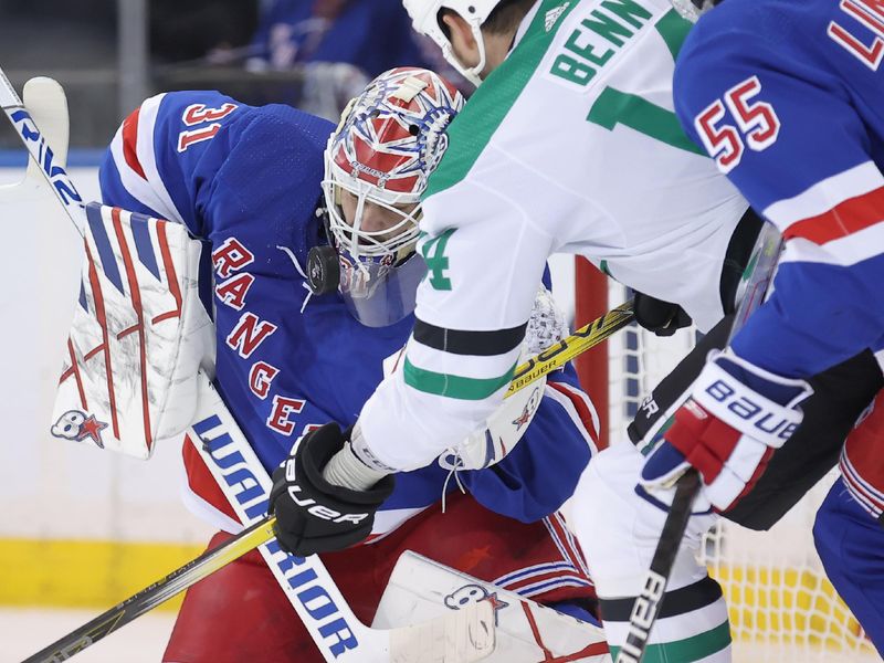 Feb 20, 2024; New York, New York, USA; New York Rangers goaltender Igor Shesterkin (31) makes a save in front of Dallas Stars left wing Jamie Benn (14) and Rangers defenseman Ryan Lindgren (55) during the second period at Madison Square Garden. Mandatory Credit: Brad Penner-USA TODAY Sports