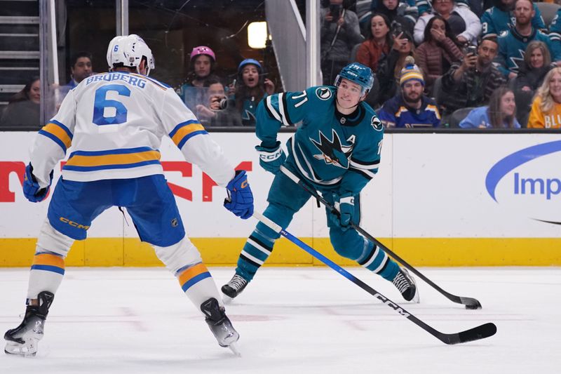 Mar 6, 2026; San Jose, California, USA; San Jose Sharks center Macklin Celebrini (71) scores a goal against while defended by St. Louis Blues defenseman Philip Broberg (6) in the second period at SAP Center at San Jose. Mandatory Credit: David Gonzales-Imagn Images