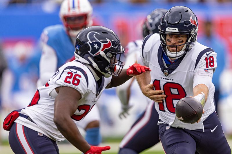 Houston Texans quarterback Case Keenum (18) turns to hand the ball off to running back Devin Singletary (26) during their NFL football game against the Tennessee Titans Sunday, Dec. 17, 2023, in Nashville, Tenn. (AP Photo/Wade Payne)