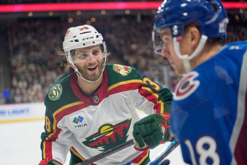 Dec 21, 2025; Saint Paul, Minnesota, USA; Minnesota Wild right wing Ryan Hartman (38) and Colorado Avalanche center Jack Drury (18) exchange words in the second period at Grand Casino Arena. Mandatory Credit: Matt Blewett-Imagn Images