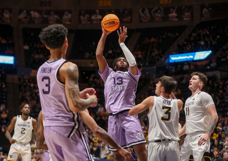 Jan 9, 2024; Morgantown, West Virginia, USA; Kansas State Wildcats forward Will McNair Jr. (13) shoots in the lane over West Virginia Mountaineers guard Kerr Kriisa (3) during the first half at WVU Coliseum. Mandatory Credit: Ben Queen-USA TODAY Sports