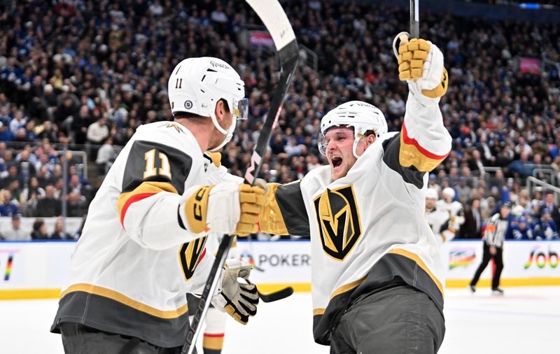 Feb 27, 2024; Toronto, Ontario, CAN;  Vegas Golden Knights forward Mason Morelli (11) celebrates with forward Sheldon Rempal (56) after scoring a goal against the Toronto Maple Leafs in the second period at Scotiabank Arena. Mandatory Credit: Dan Hamilton-USA TODAY Sports