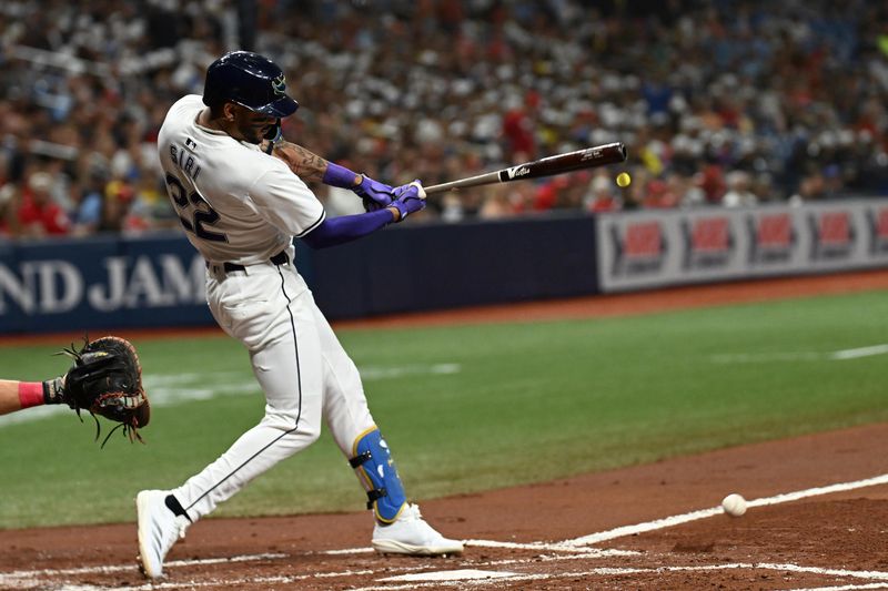 Jul 26, 2024; St. Petersburg, Florida, USA; Tampa Bay Rays center fielder Jose Siri (22) hits an RBI in the second inning against the Cincinnati Reds at Tropicana Field. Mandatory Credit: Jonathan Dyer-USA TODAY Sports