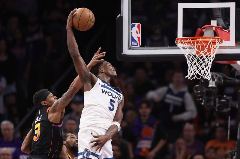 PHOENIX, ARIZONA - APRIL 28: Anthony Edwards #5 of the Minnesota Timberwolves slam dunks the ball ahead of Bradley Beal #3 of the Phoenix Suns during the second half of game four of the Western Conference First Round Playoffs at Footprint Center on April 28, 2024 in Phoenix, Arizona. The Timberwolves defeated the Suns 122-116 and win the series 4-0. NOTE TO USER: User expressly acknowledges and agrees that, by downloading and or using this photograph, User is consenting to the terms and conditions of the Getty Images License Agreement.  (Photo by Christian Petersen/Getty Images)