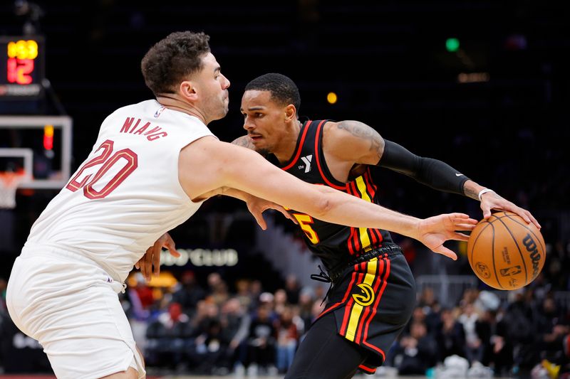 ATLANTA, GEORGIA - JANUARY 20: Georges Niang #20 of the Cleveland Cavaliers hits the ball away from Dejounte Murray #5 of the Atlanta Hawks during the second half at State Farm Arena on January 20, 2024 in Atlanta, Georgia. NOTE TO USER: User expressly acknowledges and agrees that, by downloading and or using this photograph, User is consenting to the terms and conditions of the Getty Images License Agreement. (Photo by Alex Slitz/Getty Images)