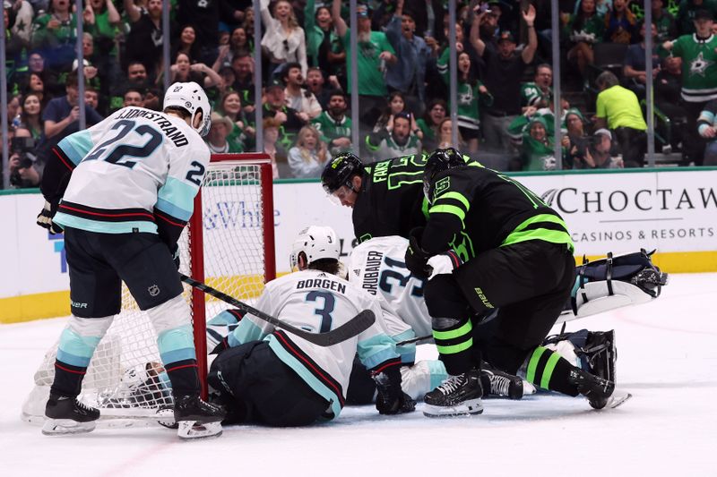 Apr 13, 2024; Dallas, Texas, USA; Dallas Stars and Seattle Kraken players scramble for the puck in the second period at American Airlines Center. Mandatory Credit: Tim Heitman-USA TODAY Sports