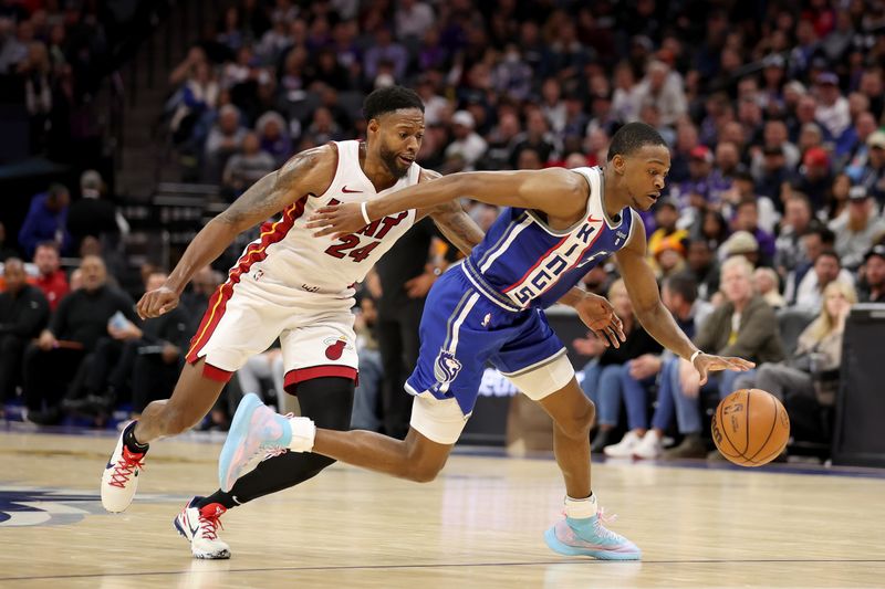 SACRAMENTO, CALIFORNIA - FEBRUARY 26: De'Aaron Fox #5 of the Sacramento Kings is guarded by Haywood Highsmith #24 of the Miami Heat in the first half at Golden 1 Center on February 26, 2024 in Sacramento, California. NOTE TO USER: User expressly acknowledges and agrees that, by downloading and or using this photograph, User is consenting to the terms and conditions of the Getty Images License Agreement.  (Photo by Ezra Shaw/Getty Images)