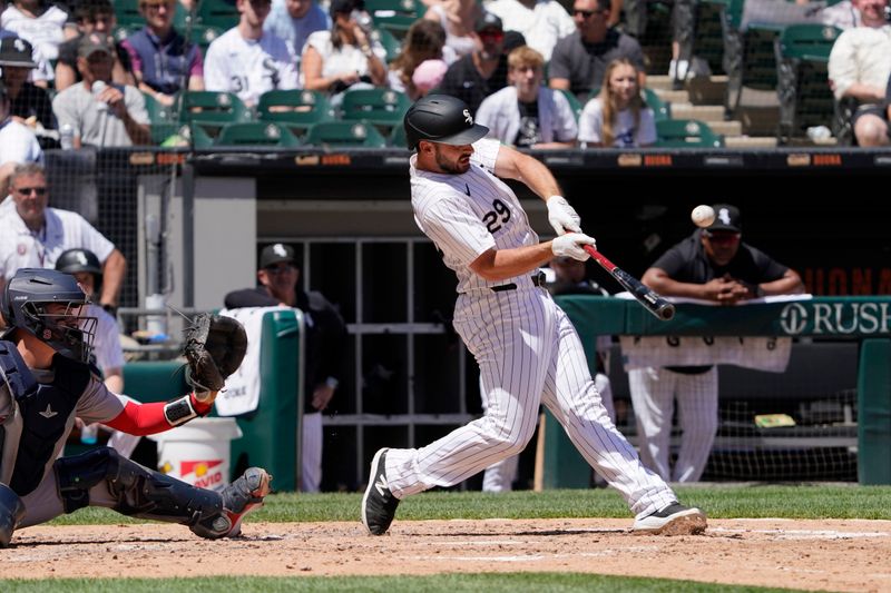 Jun 9, 2024; Chicago, Illinois, USA; Chicago White Sox shortstop Paul DeJong (29) hits a three-run home run against the Boston Red Sox during the fourth inning at Guaranteed Rate Field. Mandatory Credit: David Banks-USA TODAY Sports