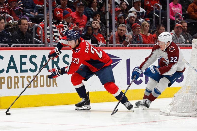 Feb 13, 2024; Washington, District of Columbia, USA; Washington Capitals center Michael Sgarbossa (23) skates with the puck as Colorado Avalanche left wing Fredrik Olofsson (22) chases in the first period at Capital One Arena. Mandatory Credit: Geoff Burke-USA TODAY Sports