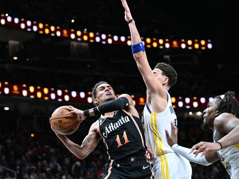 ATLANTA, GA - MARCH 17: Trae Young #11 of the Atlanta Hawks drives to the basket during the game against the Golden State Warriors on March 17, 2023 at State Farm Arena in Atlanta, Georgia.  NOTE TO USER: User expressly acknowledges and agrees that, by downloading and/or using this Photograph, user is consenting to the terms and conditions of the Getty Images License Agreement. Mandatory Copyright Notice: Copyright 2023 NBAE (Photo by Adam Hagy/NBAE via Getty Images)