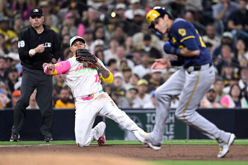 Jun 21, 2024; San Diego, California, USA; San Diego Padres third baseman Manny Machado (13) throws to first base late on a RBI single by Milwaukee Brewers first baseman Rhys Hoskins (not pictured) during the fifth inning at Petco Park. Mandatory Credit: Orlando Ramirez-USA TODAY Sports