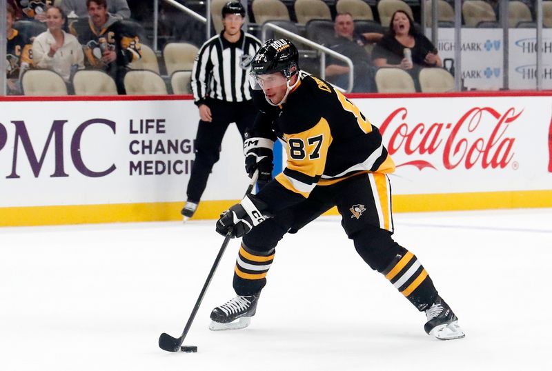 Oct 1, 2024; Pittsburgh, Pennsylvania, USA;  Pittsburgh Penguins center Sidney Crosby (87) skates with the puck against the Detroit Red Wings during the first period at PPG Paints Arena. Mandatory Credit: Charles LeClaire-Imagn Images