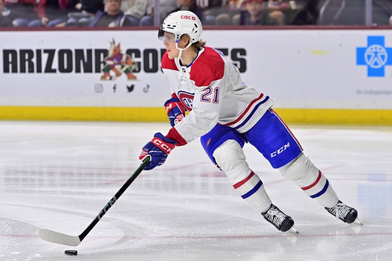 Nov 2, 2023; Tempe, Arizona, USA;  Montreal Canadiens defenseman Kaiden Guhle (21) carries the puck in the second period against the Arizona Coyotes at Mullett Arena. Mandatory Credit: Matt Kartozian-USA TODAY Sports