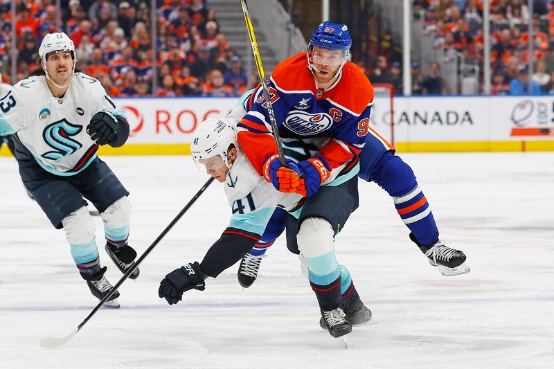 Jan 27, 2025; Edmonton, Alberta, CAN; Seattle Kraken defensemen Ryker Evans (41) checks Edmonton Oilers forward Connor McDavid (97) during the third period at Rogers Place. Mandatory Credit: Perry Nelson-Imagn Images