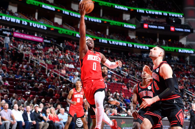 HOUSTON, TX - MARCH 21:   Aaron Holiday #0 of the Houston Rockets drives to the basket during the game against the Chicago Bulls on March 21, 2024 at the Toyota Center in Houston, Texas. NOTE TO USER: User expressly acknowledges and agrees that, by downloading and or using this photograph, User is consenting to the terms and conditions of the Getty Images License Agreement. Mandatory Copyright Notice: Copyright 2024 NBAE (Photo by Logan Riely/NBAE via Getty Images)