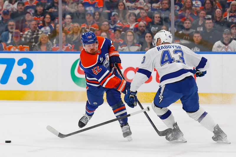 Mar 21, 2026; Edmonton, Alberta, CAN; Tampa Bay Lightning defensemen Darren Raddysh (43) blocks a shot by Edmonton Oilers forward Kasperi Kapanen (42) during the first period at Rogers Place. Mandatory Credit: Perry Nelson-Imagn Images