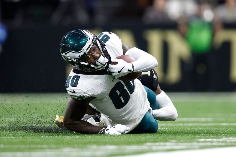 Philadelphia Eagles wide receiver Parris Campbell (80) is tackled by New Orleans Saints cornerback Alontae Taylor (1) during an NFL football game, Sunday, Sept. 22, 2024, in New Orleans. (AP Photo/Tyler Kaufman)