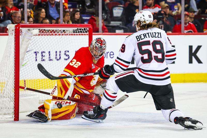 Nov 7, 2025; Calgary, Alberta, CAN; Calgary Flames goaltender Dustin Wolf (32) makes a save against Chicago Blackhawks left wing Tyler Bertuzzi (59) during the third period at Scotiabank Saddledome. Mandatory Credit: Sergei Belski-Imagn Images