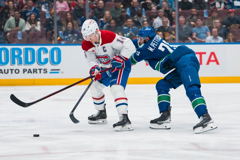 Mar 11, 2025; Vancouver, British Columbia, CAN; Vancouver Canucks defenseman Marcus Pettersson (29) stick checks Montreal Canadiens forward Nick Suzuki (14) in the first period at Rogers Arena. Mandatory Credit: Bob Frid-Imagn Images