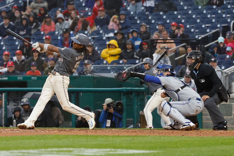 May 4, 2024; Washington, District of Columbia, USA; Washington Nationals shortstop CJ Abrams (5) hits an RBI sacrifice fly against the Toronto Blue Jays during the seventh inning at Nationals Park. Mandatory Credit: Geoff Burke-USA TODAY Sports