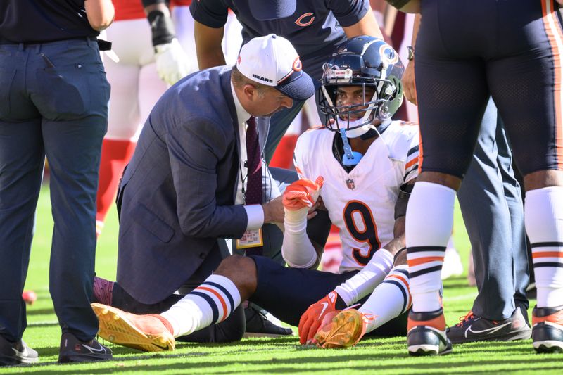 Chicago Bears safety Jaquan Brisker (9) is looked at after being shaken up during the first half of an NFL football game against the Kansas City Chiefs, Sunday, Sept. 24, 2023 in Kansas City, Mo. (AP Photo/Reed Hoffmann)