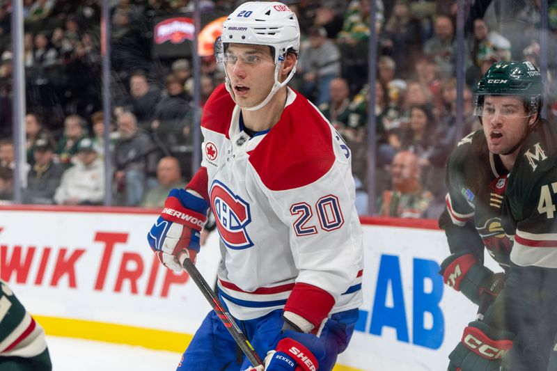 Nov 14, 2024; Saint Paul, Minnesota, USA; Montreal Canadiens left wing Juraj Slafkovsky (20) gets back in the play after checking Minnesota Wild defenseman Declan Chisholm (47) in the third period at Xcel Energy Center. Mandatory Credit: Matt Blewett-Imagn Images