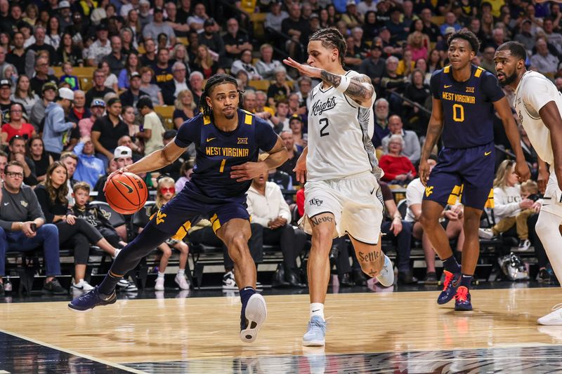 Feb 14, 2026; Orlando, Florida, USA; West Virginia Mountaineers guard Jasper Floyd (1) drives against UCF Knights guard Riley Kugel (2) during the first half at Addition Financial Arena. Mandatory Credit: Mike Watters-Imagn Images