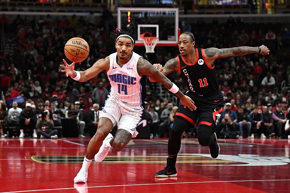 CHICAGO, ILLINOIS - NOVEMBER 17: Gary Harris #14 of the Orlando Magic goes after the ball in the first half of an NBA In-Season Tournament against DeMar DeRozan #11 of the Chicago Bulls at the United Center on November 17, 2023 in Chicago, Illinois.  NOTE TO USER: User expressly acknowledges and agrees that, by downloading and or using this photograph, User is consenting to the terms and conditions of the Getty Images License Agreement.  (Photo by Quinn Harris/Getty Images)