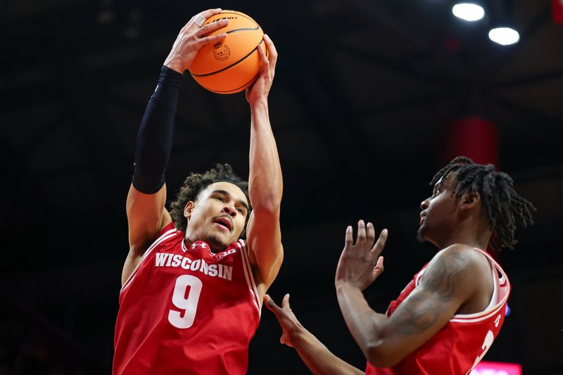 Jan 6, 2025; Piscataway, New Jersey, USA; Wisconsin Badgers guard John Tonje (9) rebounds in front of guard Camren Hunter (3) during the second half against the Rutgers Scarlet Knights at Jersey Mike's Arena. Mandatory Credit: Vincent Carchietta-Imagn Images