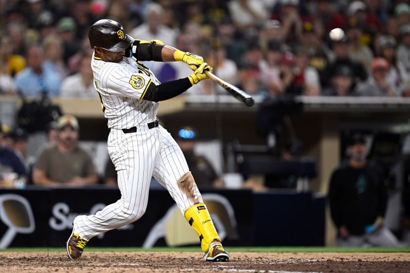 Jul 6, 2024; San Diego, California, USA; San Diego Padres designated hitter Donovan Solano (39) hits an RBI double against the Arizona Diamondbacks during the tenth inning at Petco Park. Mandatory Credit: Orlando Ramirez-USA TODAY Sports