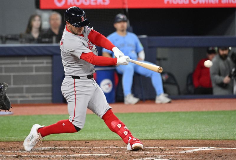 May 1, 2025; Toronto, Ontario, CAN;  Boston Red Sox third baseman Alex Bregman (2) hits a two run RBI double against the Toronto Blue Jays in the fifth inning at Rogers Centre. Mandatory Credit: Dan Hamilton-Imagn Images
