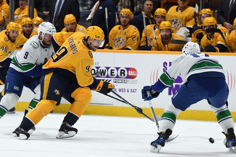 Dec 19, 2023; Nashville, Tennessee, USA; Nashville Predators left wing Filip Forsberg (9) skates the puck into the offensive zone against Vancouver Canucks defenseman Filip Hronek (17) during the first period at Bridgestone Arena. Mandatory Credit: Christopher Hanewinckel-USA TODAY Sports