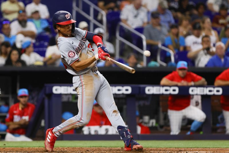 Apr 27, 2024; Miami, Florida, USA; Washington Nationals third baseman Trey Lipscomb (38) hits a single against the Miami Marlins during the fifth inning at loanDepot Park. Mandatory Credit: Sam Navarro-USA TODAY Sports