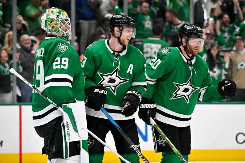 May 25, 2024; Dallas, Texas, USA; Dallas Stars goaltender Jake Oettinger (29) and defenseman Esa Lindell (23) and defenseman Ryan Suter (20) celebrate on the ice after the Dallas Stars defeat the Edmonton Oilers in game two of the Western Conference Final of the 2024 Stanley Cup Playoffs at American Airlines Center. Mandatory Credit: Jerome Miron-USA TODAY Sports