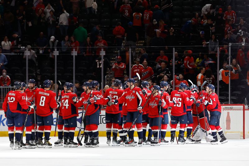 Oct 23, 2024; Washington, District of Columbia, USA; Washington Capitals players celebrate after their game against the Philadelphia Flyers at Capital One Arena. Mandatory Credit: Geoff Burke-Imagn Images