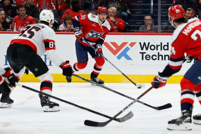 Oct 25, 2025; Washington, District of Columbia, USA; Washington Capitals left wing Pierre-Luc Dubois (80) skates with the puck against as Ottawa Senators defenseman Jake Sanderson (85) defends during the first period at Capital One Arena. Mandatory Credit: Geoff Burke-Imagn Images