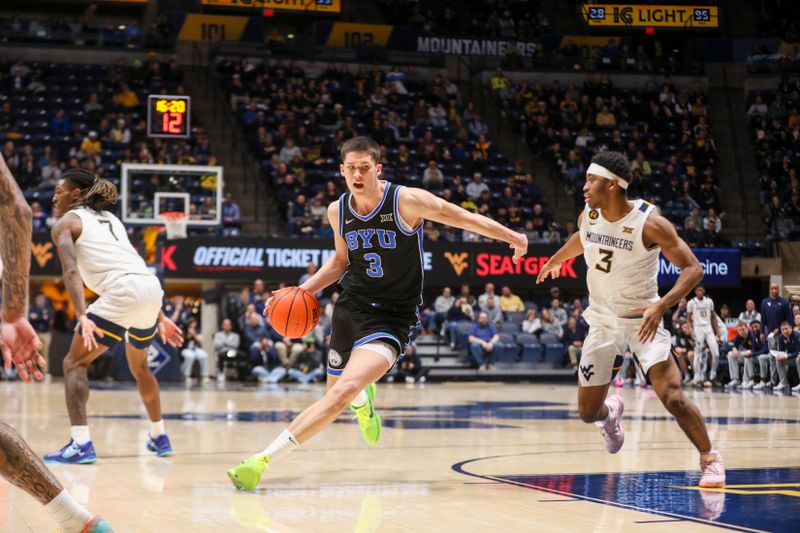 Feb 11, 2025; Morgantown, West Virginia, USA; Brigham Young Cougars guard Egor Demin (3) drives down the lane against West Virginia Mountaineers guard KJ Tenner (3) during the second half at WVU Coliseum. Mandatory Credit: Ben Queen-Imagn Images