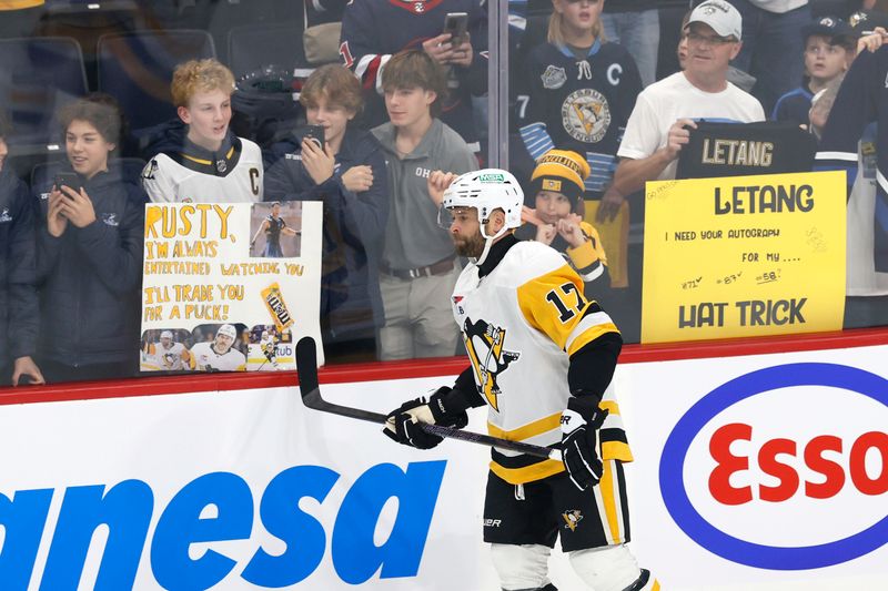 Oct 20, 2024; Winnipeg, Manitoba, CAN; Pittsburgh Penguins right wing Bryan Rust (17) skates past fans before a game against the Winnipeg Jets at Canada Life Centre. Mandatory Credit: James Carey Lauder-Imagn Images