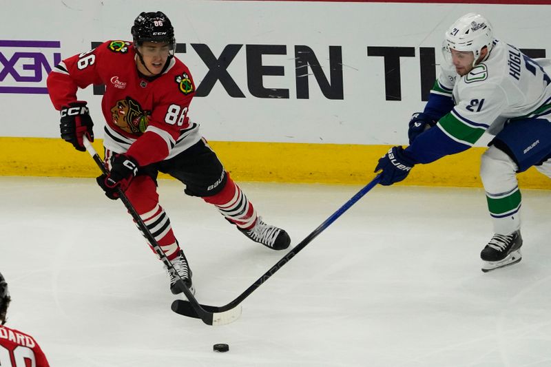 Oct 22, 2024; Chicago, Illinois, USA; Vancouver Canucks left wing Nils Hoglander (21) defends Chicago Blackhawks center Teuvo Teravainen (86) during the first period at United Center. Mandatory Credit: David Banks-Imagn Images